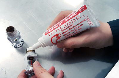 Thread sealant is applied to fire sprinkler heads prior to installation